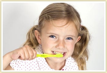 little girl brushing her teeth