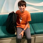 boy in orange shirt sitting