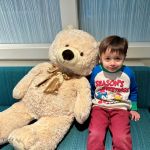 a boy with a big teddy bear