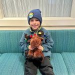 a boy with a small stuff toy