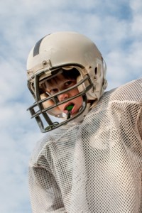 A boy wearing a football gear